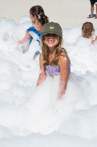 Kids playing at foam party at the beach