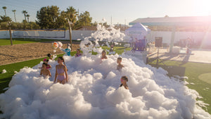 Children having a foam party in a park