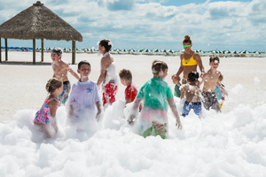 Kids playing at foam party at the beach